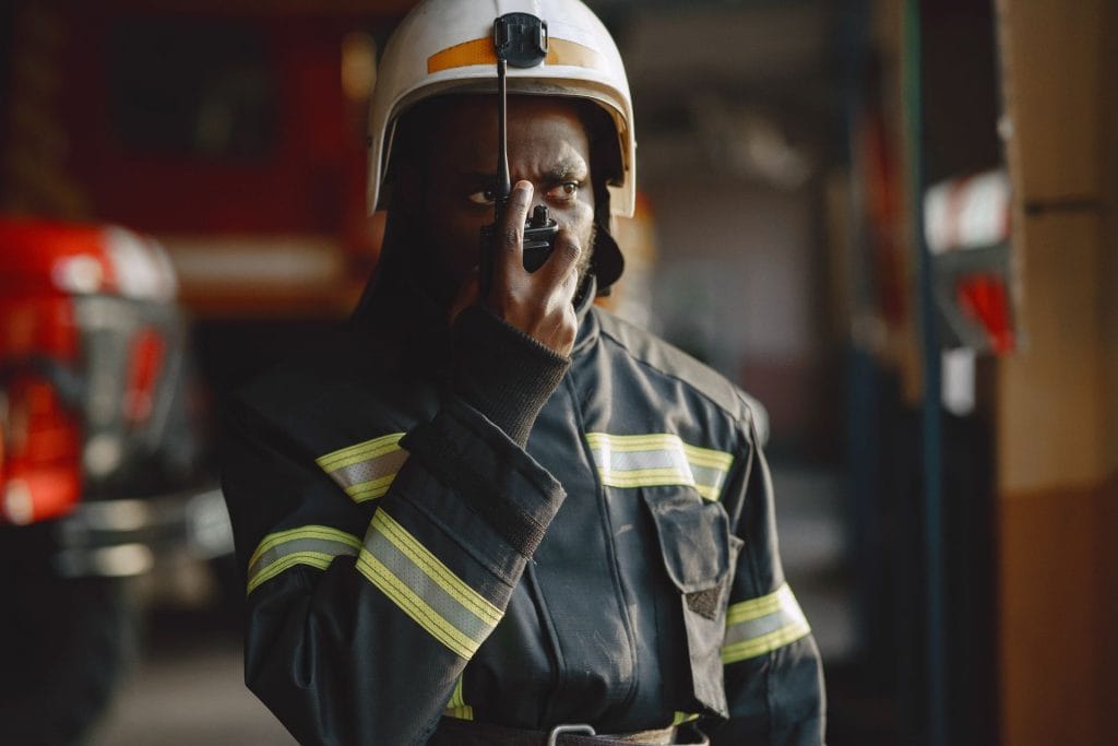 Firefighter using a walkie-talkie to coordinate an emergency response
